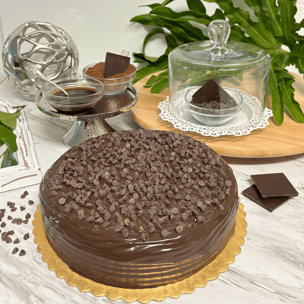 Gluten-free, dairy-free, sugar-free Vanilla and Chocolate cake, featuring layers of moist vanilla and rich dark chocolate, topped with sugar-free chocolate syrup and extra chocolate chips for a luxurious finish. Full Life Gourmet Bakery